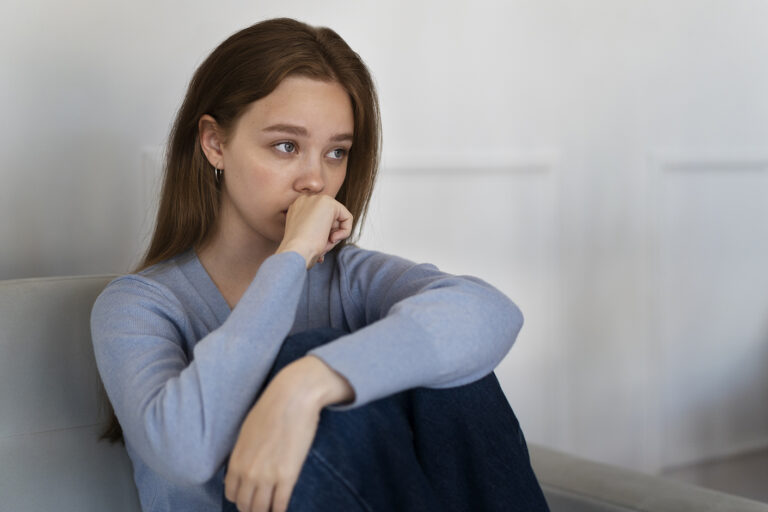 side-view-worried-woman-sitting-couch